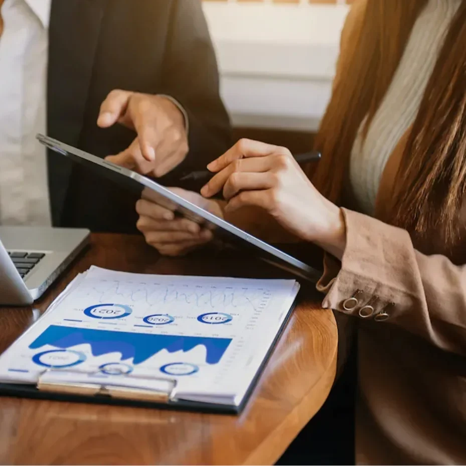 partners hands reviewing financial charts with tablet